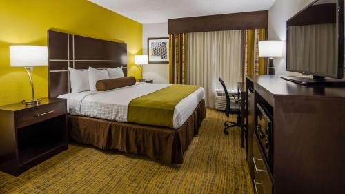 a hotel room with a bed and a television at Best Western Plus Hanes Mall in Winston-Salem