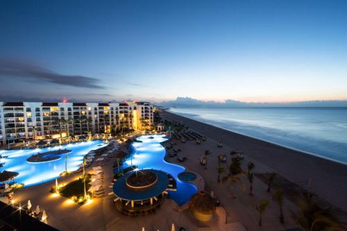 a view of the beach and the ocean at night at Hyatt Ziva Los Cabos - All Inclusive in San José del Cabo