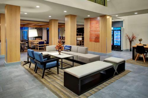 a lobby with a couch and a table and chairs at Hyatt House Dallas Lincoln Park in Dallas