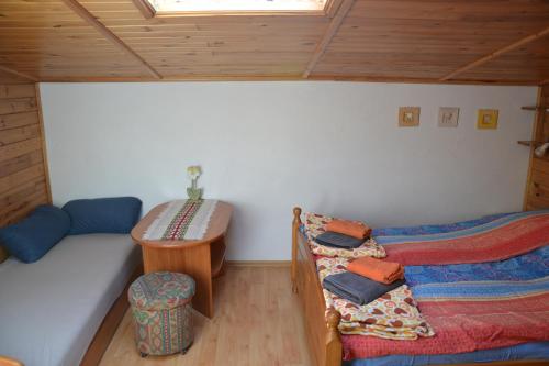 a room with two beds and a table in a cabin at Apartament nad Jeziorem Necko in Augustów