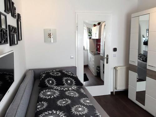 a bedroom with a bed with a black and white pillow at Studio Typ-Apartment "La Marie" in Schwäbisch Gmünd