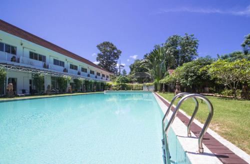 a swimming pool next to a building at Rajapruek Samui Resort - SHA Plus in Lipa Noi