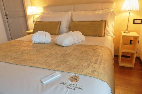 a bedroom with a bed with towels on it at RELAIS VAL D'ORCIA in Pienza