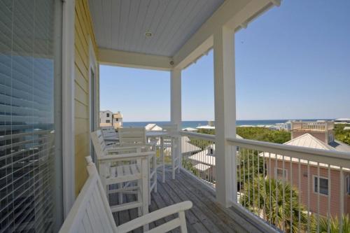 a porch with chairs and a view of the ocean at A Point of View in Seagrove Beach