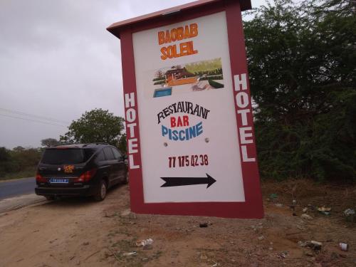 a sign for a bar reserve on the side of the road at Baobab Soleil in Sindia