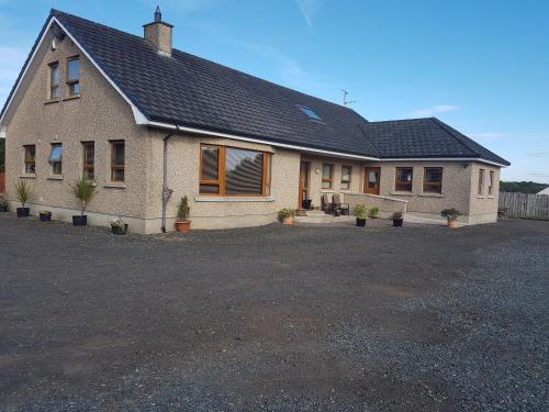 a house with a solar roof on a driveway at Rockhill hospitality in Coleraine