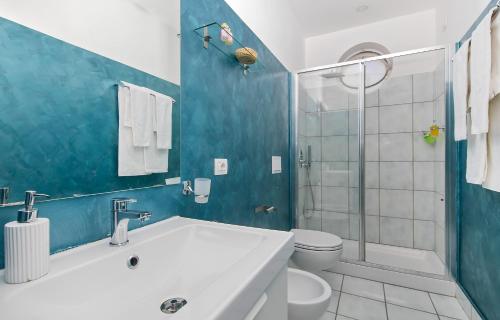 a bathroom with a sink and a toilet and a shower at Elisir B&B in Anacapri