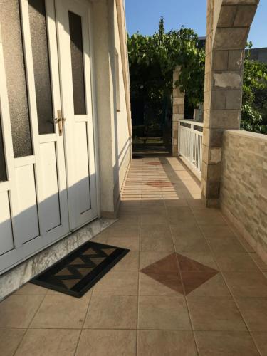 a walkway leading to a door of a house at Room Ivana in Neum