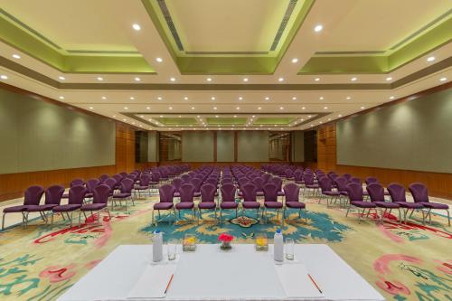 a large room with purple chairs and tables in it at Welcomhotel by ITC Hotels, Jodhpur in Jodhpur