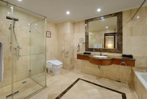 a bathroom with a shower and a toilet and a sink at Le Midi Hotel Jungli in Zhongli
