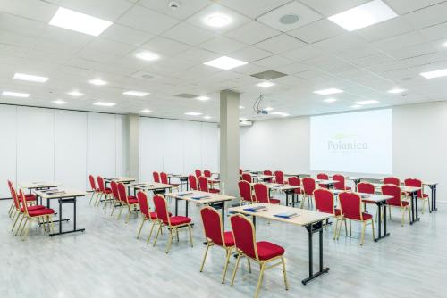 a conference room with tables and red chairs at Hotel Polanica Resort & Spa in Polanica-Zdrój