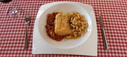 a white plate of food on a table at Hotel-Hostal Sport in Falset