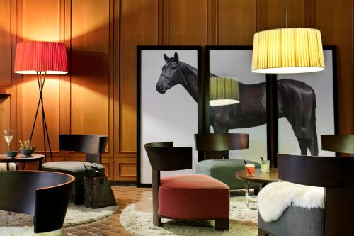 a lobby with a picture of a horse on the wall at Hotel Tremoggia in Chiesa in Valmalenco