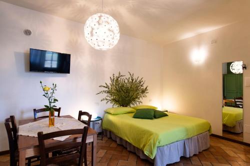 a bedroom with a bed and a table and a tv at Orvieto Rocca Fiorita in Orvieto