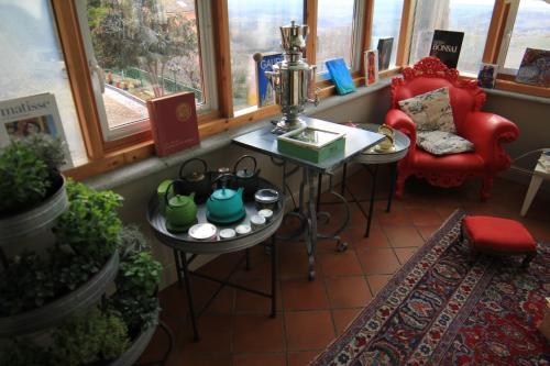 a room with a table and a chair and windows at Felicin - Ristorante Albergo "Dimora Storica" in Monforte dʼAlba