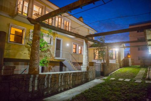 a house with a stone wall and stairs in front at Hospedagem Casa das Regadas in Vale de Cambra