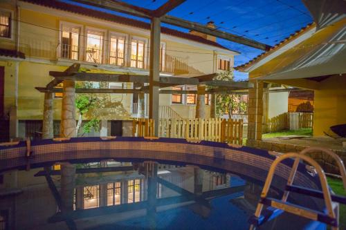 a house with a swimming pool in front of a house at Hospedagem Casa das Regadas in Vale de Cambra