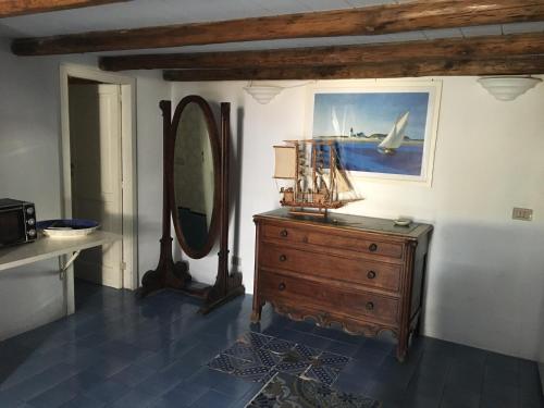 a room with a wooden dresser and a mirror at Villa in Panarea - Nespolo in Panarea