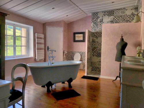 a bathroom with a large tub in a room at Château de Perpezat in Apchat