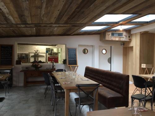 a dining room with wooden tables and chairs at Pyrenees Resort in Argelès-Gazost