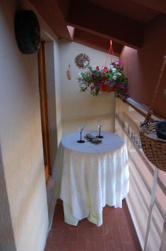 a table on a balcony with flowers on it at Le Coin Vert in Fregene