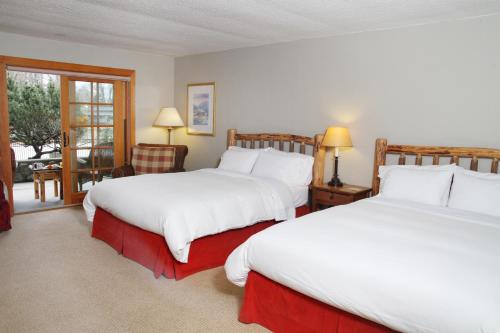 a hotel room with two beds and a window at The Lodge at Riverside in Grants Pass