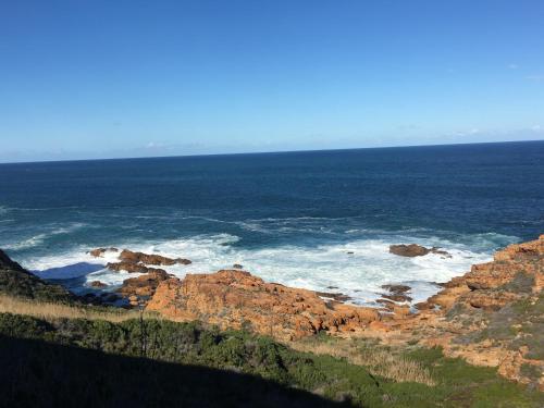 a view of the ocean with rocks and the ocean at Tranquillo in Mossel Bay