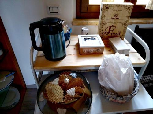 a table with a coffee pot and a basket on it at Il Giardino Di Epicuro in Rocca San Giovanni