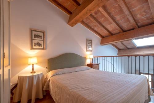 a bedroom with a bed and a table with a lamp at Poggio all'Agnello Sport & Family Holidays in Populonia