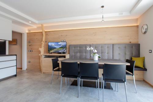 a kitchen and dining room with a table and chairs at Bellavista - Lake in Molveno