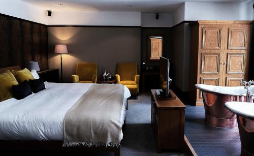 a hotel room with a bed and a bathroom at Hotel du Vin & Bistro Cambridge in Cambridge