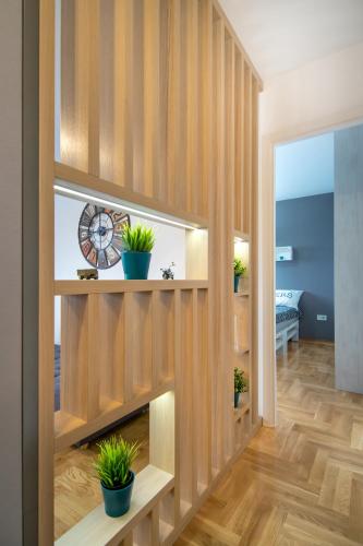a hallway with wooden walls and potted plants at VortexLuxApatman in Belgrade