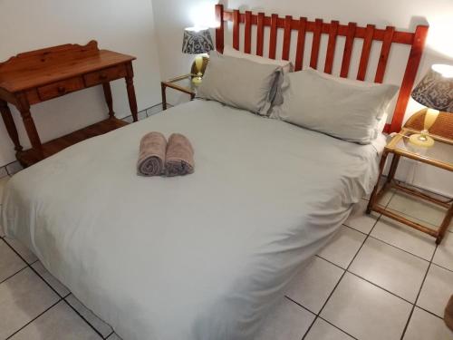 a bedroom with a bed with two slippers on it at 62 The Bridge Holiday Resort in St Lucia