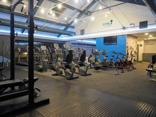 a gym with several treadmills and cardio machines at Tullamore Court Hotel in Tullamore