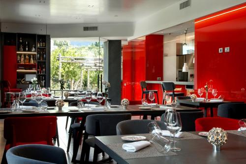 a restaurant with tables and chairs and red walls at Il San Cristoforo in Ercolano