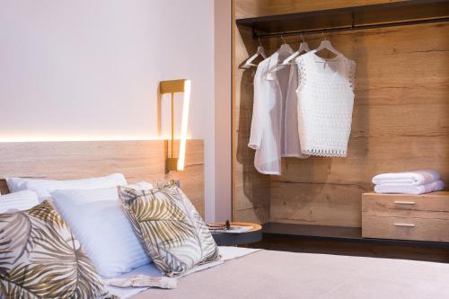 a bedroom with a bed with white pillows and a closet at On The Rocks in Theologos