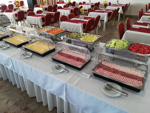 a buffet table with many different types of food on it at Hotel SATEL in Poprad
