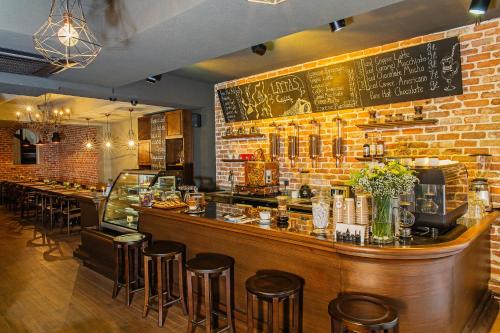 a bar in a restaurant with a brick wall at Meroddi Galata Mansion in Istanbul