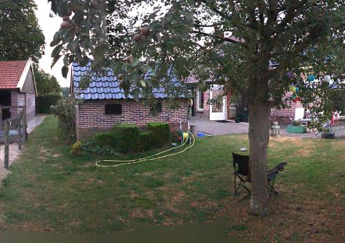 a house with a hose hooked up to a tree at B&B Zandhuizen in Zandhuizen