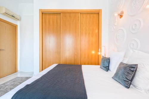 a bedroom with a bed with a wooden headboard at iloftmalaga Deluxe Alameda Principal in Málaga