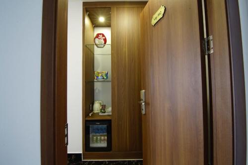 a door leading into a room with a shelf at Green Hadong Hotel in Hà Ðông