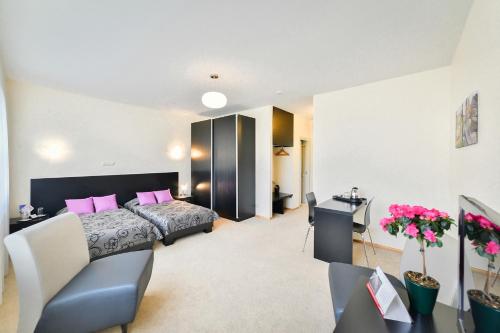 a bedroom with a bed with pink pillows at Superior Hotel Vantis Riverside in Rīga