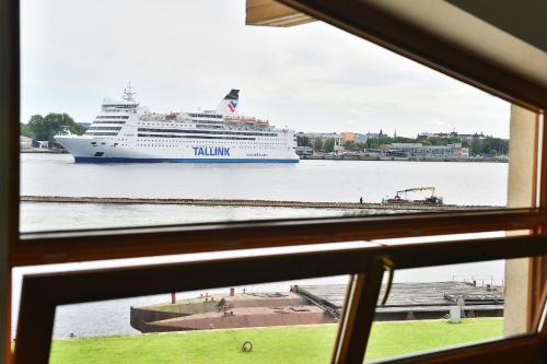 a cruise ship is docked in the water at Superior Hotel Vantis Riverside in Rīga