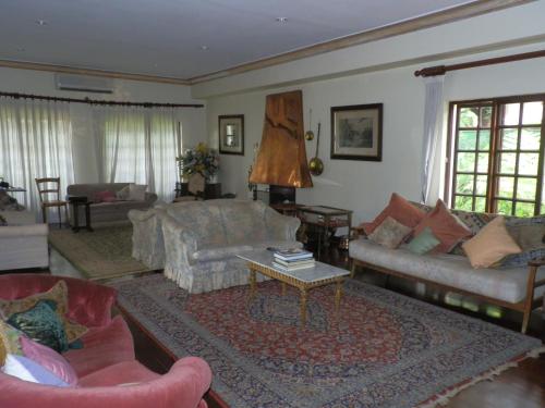 a living room with couches and a coffee table at 12 FLEETWOOD in Harare