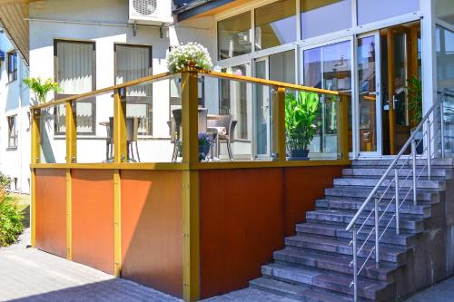 a house with a yellow and orange porch at Superior Hotel Vantis Riverside in Rīga
