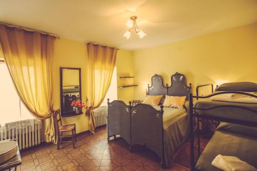 a bedroom with two beds and a mirror at Agriturismo I Surì Asti in Asti