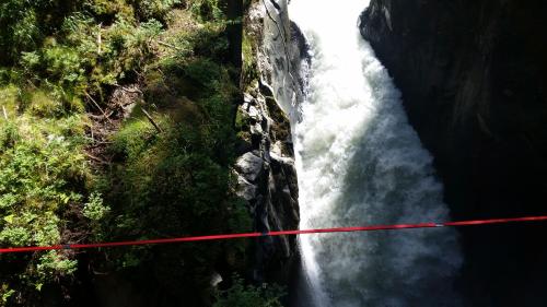 an aerial view of a waterfall with a red line at Chalet Stubai inklusive Stubai Super Card in Fulpmes