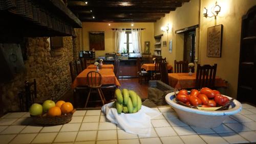 a kitchen with a table with fruits and vegetables on it at Casa rural Can Jepet in La Cellera de Ter