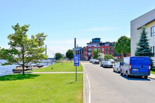 a street with cars parked on the side of the road at Superior Hotel Vantis Riverside in Rīga