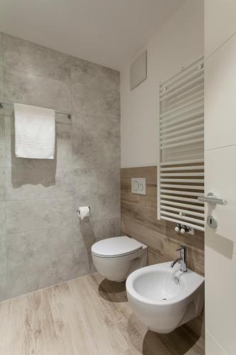 a bathroom with a white toilet and a sink at Bellavista - Lake in Molveno